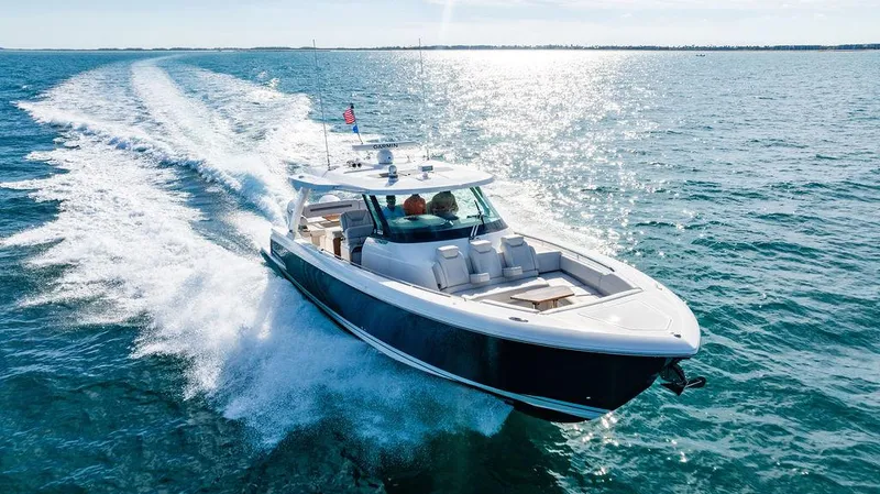 Slide: The Image of 2022 Tiara Yachts 43 LS cruising on open water under clear skies. - 1