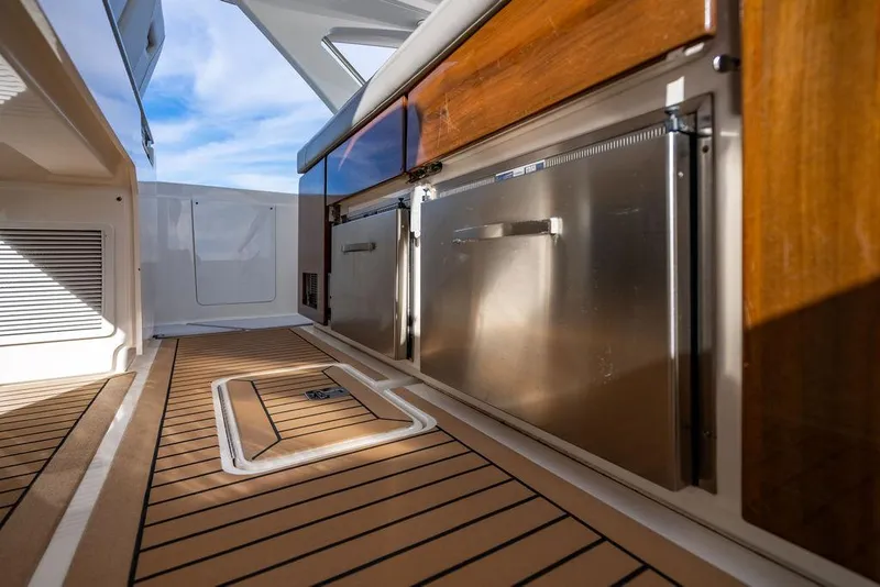 Slide: The Image of 2022 Tiara Yachts 43 LS interior with wood and stainless steel finishes. - 12