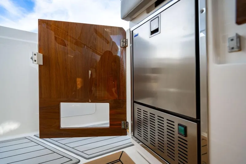 Slide: The Image of 2022 Tiara Yachts 43 LS interior with wooden door and stainless steel appliance. - 13