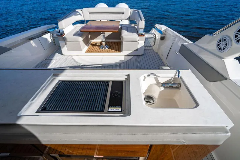 Slide: The Image of 2022 Tiara Yachts 43 LS featuring outdoor kitchen and seating area on a sunny day. - 14