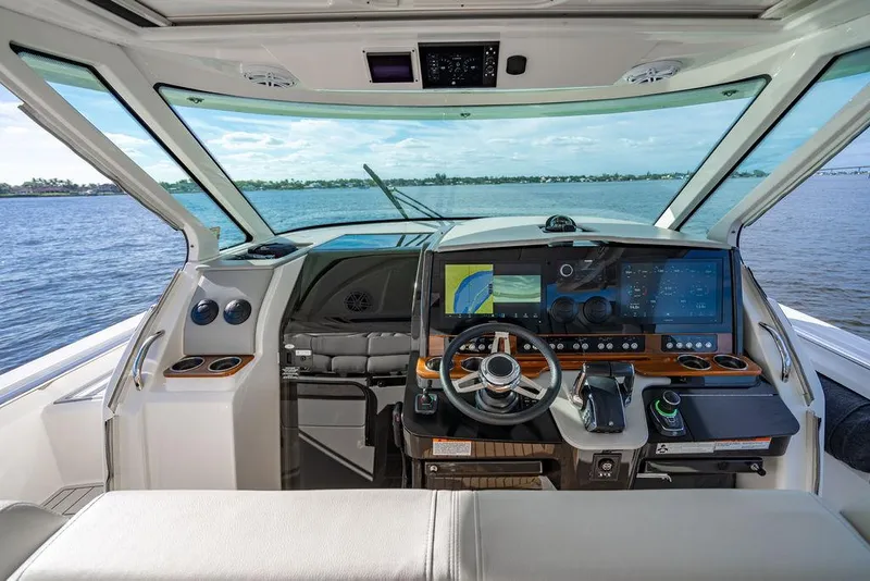 Slide: The Image of 2022 Tiara Yachts 43 LS helm with advanced navigation system and panoramic water view. - 15