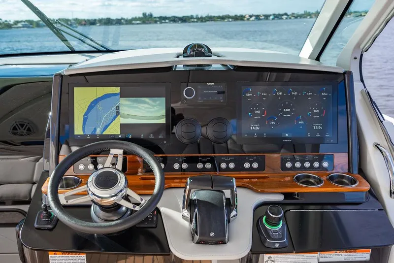 Slide: The Image of 2022 Tiara Yachts 43 LS helm with advanced navigation displays and controls. - 16