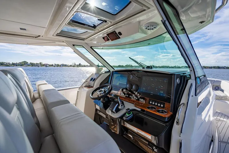 Slide: The Image of 2022 Tiara Yachts 43 LS helm with modern controls and panoramic water view. - 17