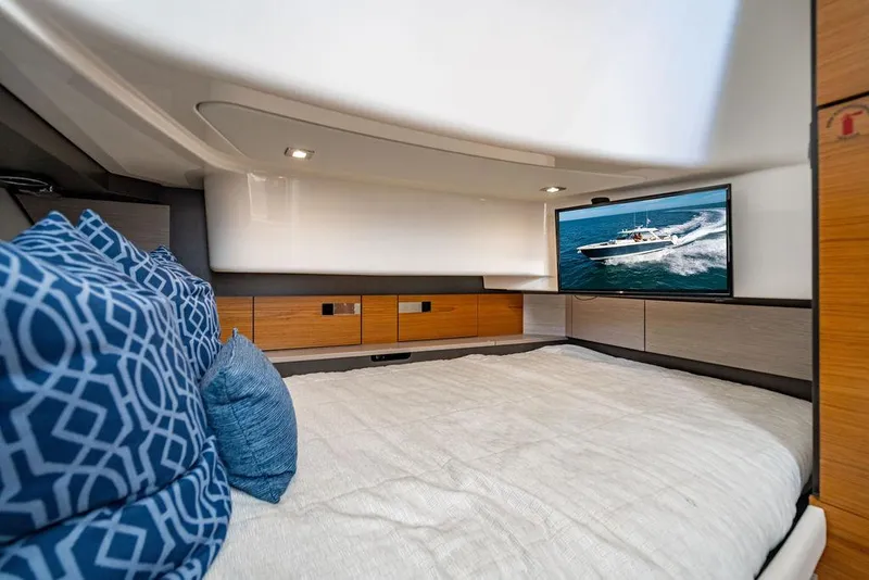 Slide: The Image of Interior cabin of 2022 Tiara Yachts 43 LS with bed, pillows, and TV. - 21