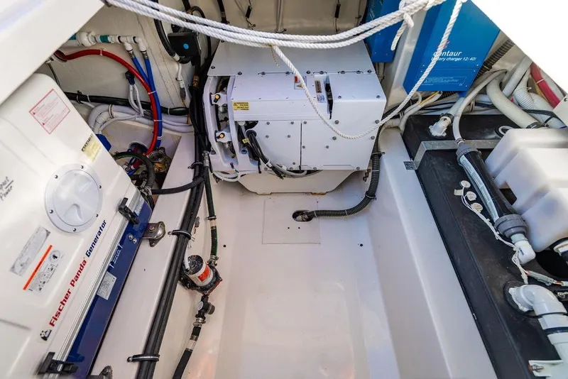 Slide: The Image of Engine room of 2022 Tiara Yachts 43 LS, showcasing equipment and wiring. - 23