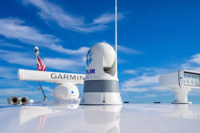 Slide: The Image of 2022 Tiara Yachts 43 LS with Garmin and FLIR equipment against a blue sky. - 25