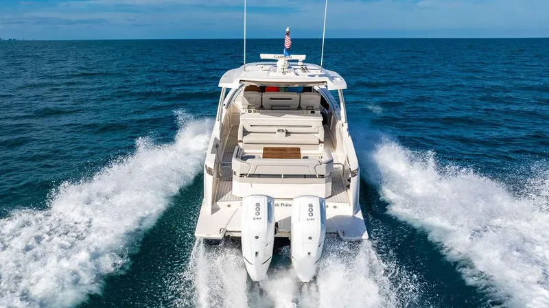Slide: The Image of 2022 Tiara Yachts 43 LS cruising on open sea, rear view. - 3