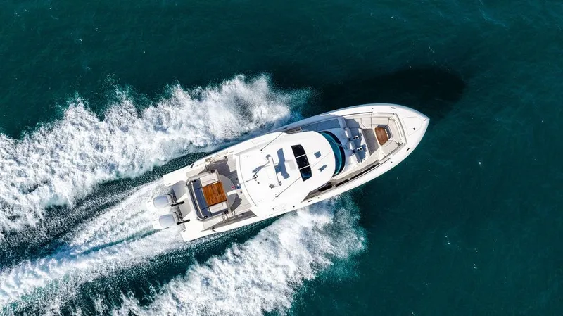 Slide: The Image of Aerial view of 2022 Tiara Yachts 43 LS cruising on open water. - 4