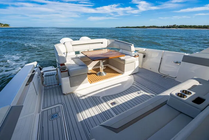 Slide: The Image of 2022 Tiara Yachts 43 LS luxury deck with seating and table on open water. - 5