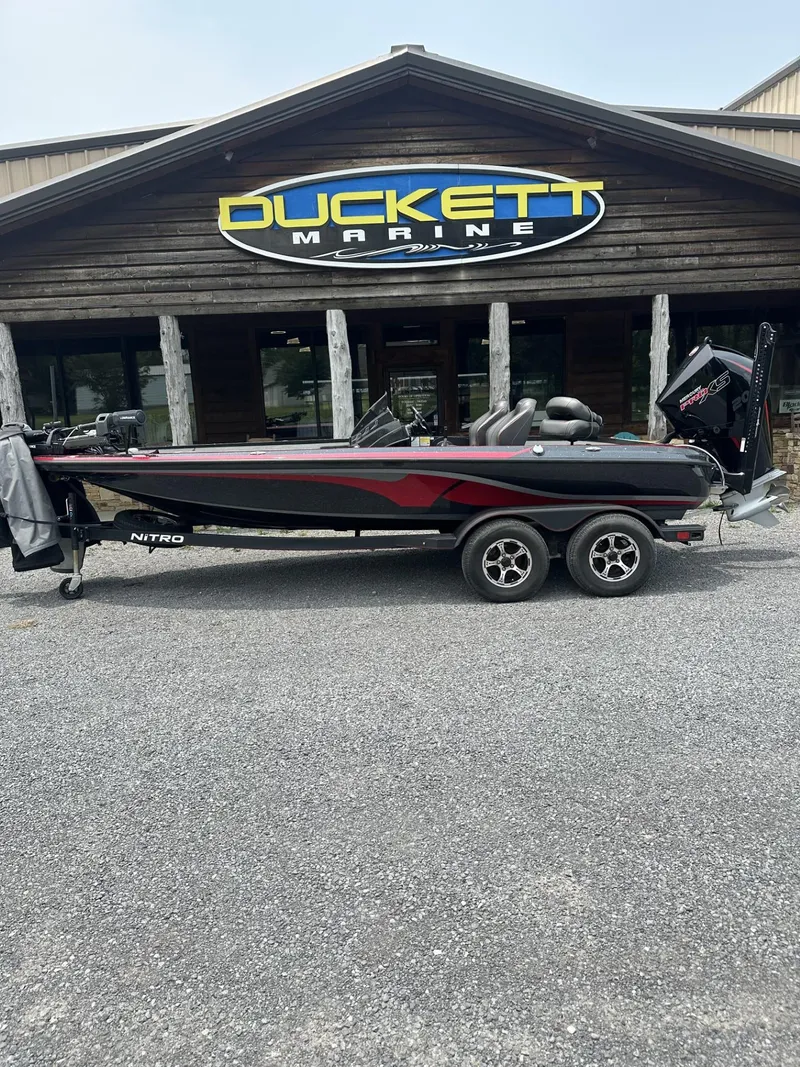 Slide: The Image of 2024 Nitro Z19 boat parked outside Duckett Marine store. - 11