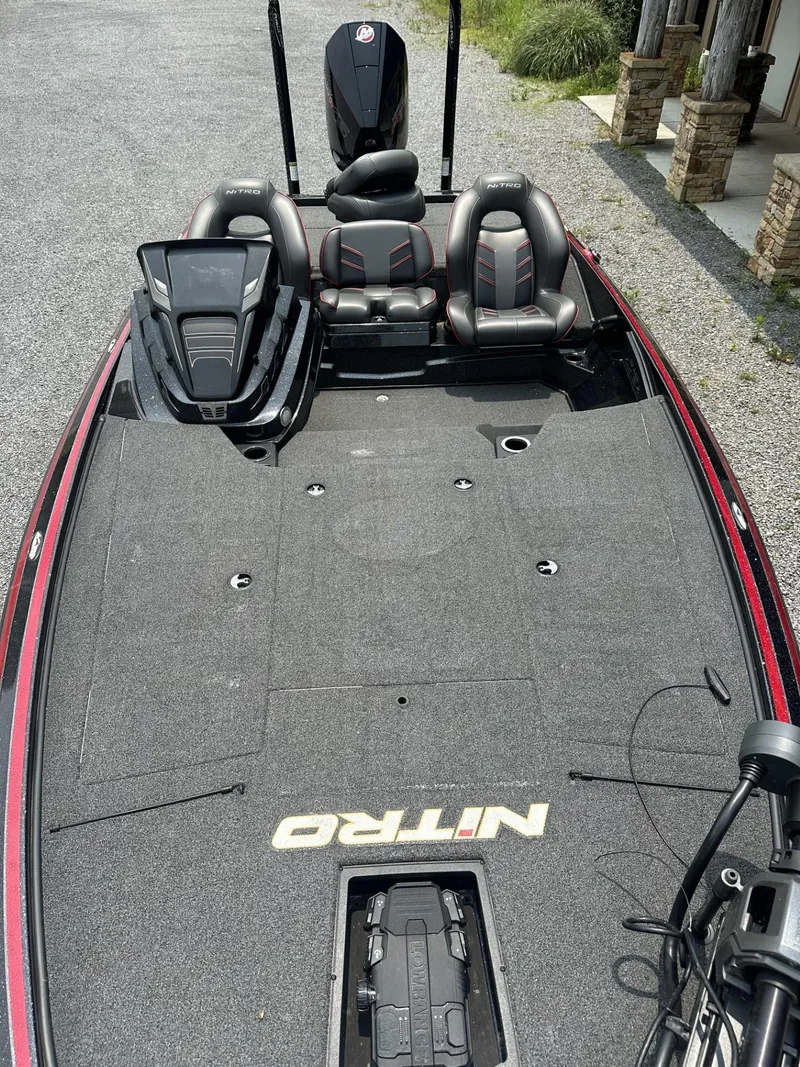 Slide: The Image of 2024 Nitro Z19 boat with spacious deck and dual seating, parked on gravel. - 4
