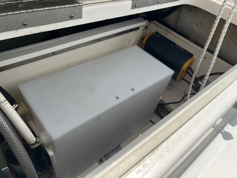 Slide: The Image of 2018 Robalo 246 Cayman boat storage compartment with equipment and wiring. - 11