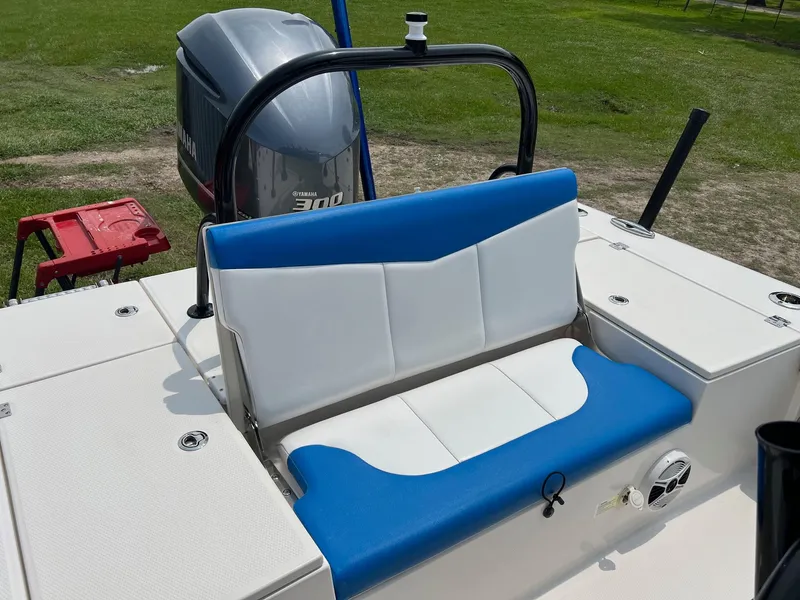 Slide: The Image of 2018 Robalo 246 Cayman boat with blue and white seating, Yamaha engine in background. - 12