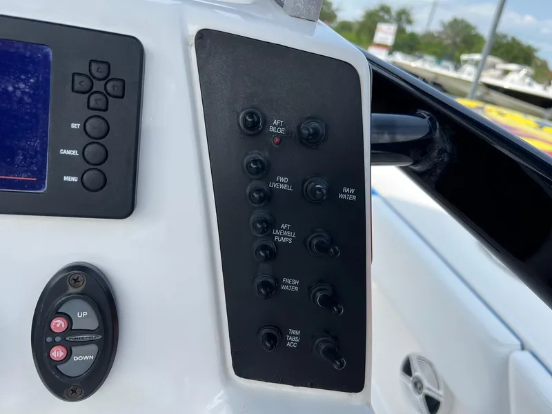 Slide: The Image of Control panel of a 2018 Robalo 246 Cayman boat with various switches and buttons. - 15