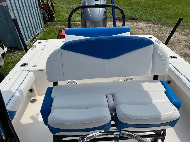 Slide: The Image of 2018 Robalo 246 Cayman boat interior with blue and white seating. - 19
