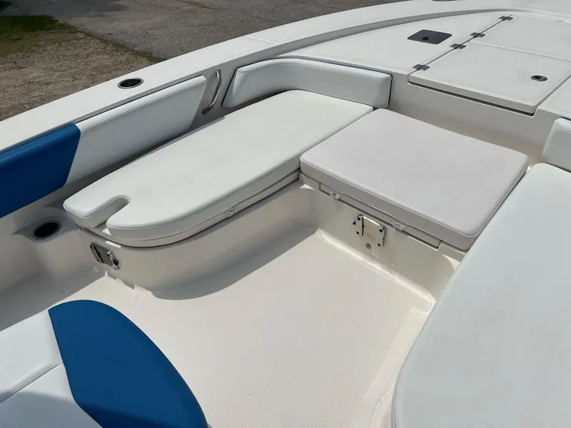 Slide: The Image of 2018 Robalo 246 Cayman boat interior with white and blue seating. - 22
