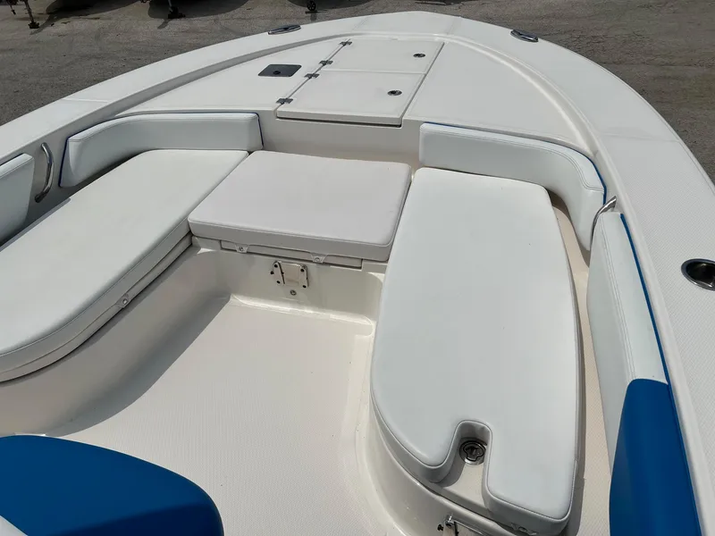 Slide: The Image of 2018 Robalo 246 Cayman boat interior with white cushioned seating. - 24