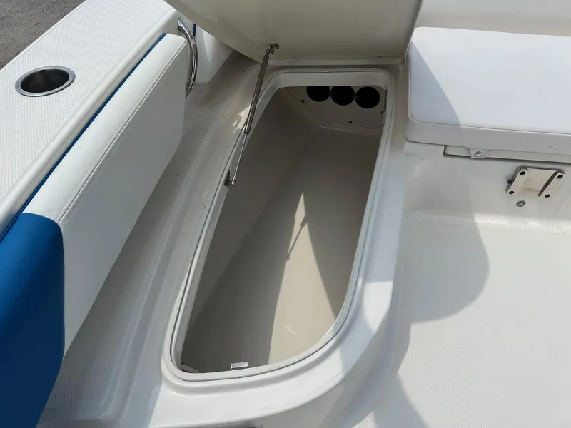 Slide: The Image of 2018 Robalo 246 Cayman boat storage compartment with open lid. - 28
