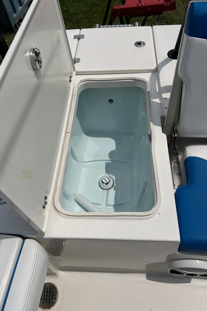 Slide: The Image of 2018 Robalo 246 Cayman boat livewell with open lid and blue seating. - 32