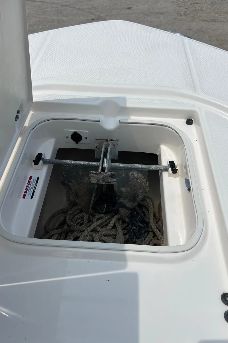Slide: The Image of 2018 Robalo 246 Cayman anchor storage compartment with rope and anchor. - 34