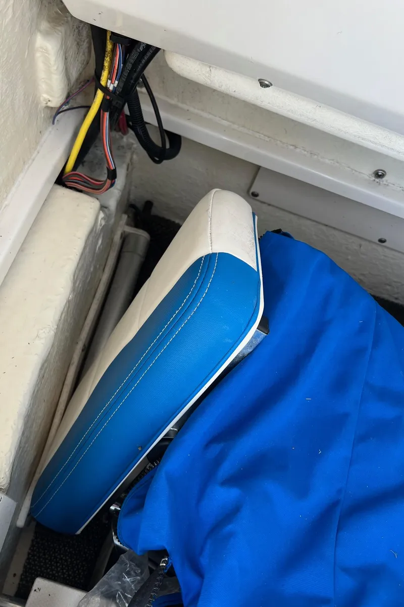 Slide: The Image of 2018 Robalo 246 Cayman boat interior with blue and white seat cushion. - 37