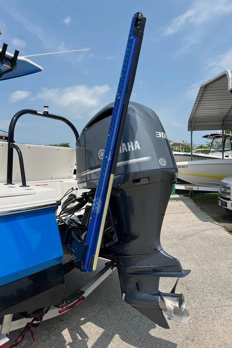 Slide: The Image of 2018 Robalo 246 Cayman boat with Yamaha outboard motor, docked under clear sky. - 38