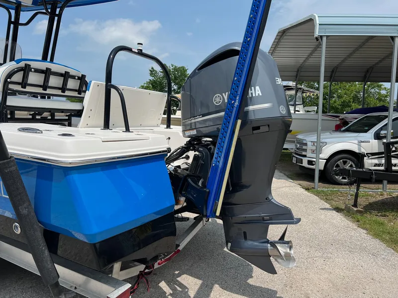 Slide: The Image of 2018 Robalo 246 Cayman boat with Yamaha outboard motor, parked near a covered area. - 6