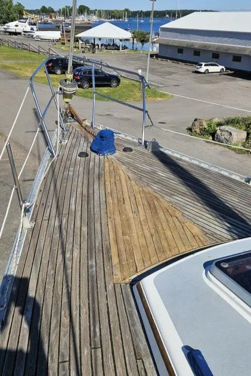 Slide: The Image of 1983 Cheoy Lee Pedrick 41 sailboat deck with wooden finish, docked near marina. - 11