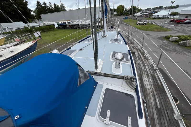 Slide: The Image of 1983 Cheoy Lee Pedrick 41 sailboat deck with blue cover, docked in a marina. - 12