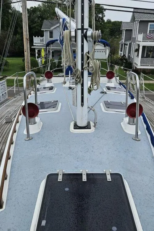 Slide: The Image of 1983 Cheoy Lee Pedrick 41 sailboat deck with hatches and rigging, docked near residential area. - 14