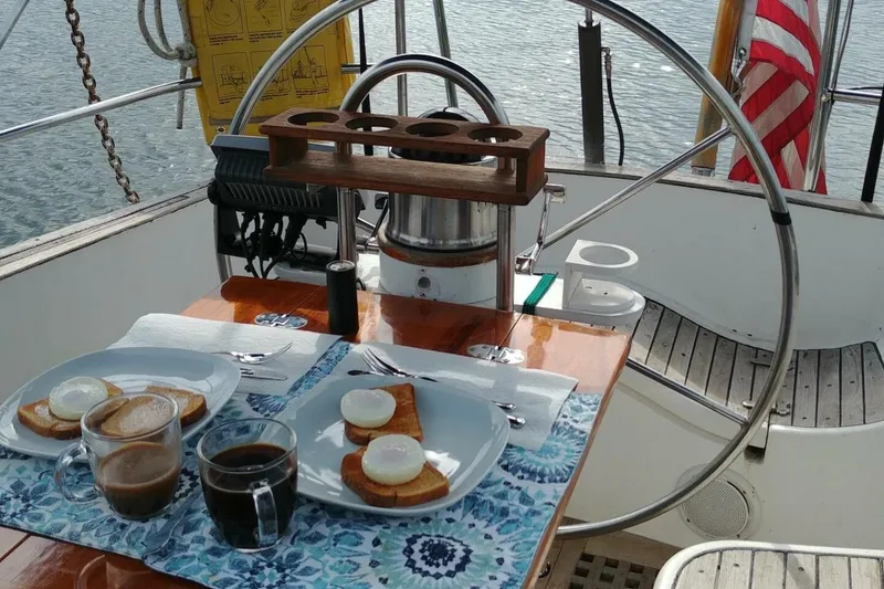 Slide: The Image of Breakfast setup on 1983 Cheoy Lee Pedrick 41 sailboat, featuring poached eggs and coffee. - 19