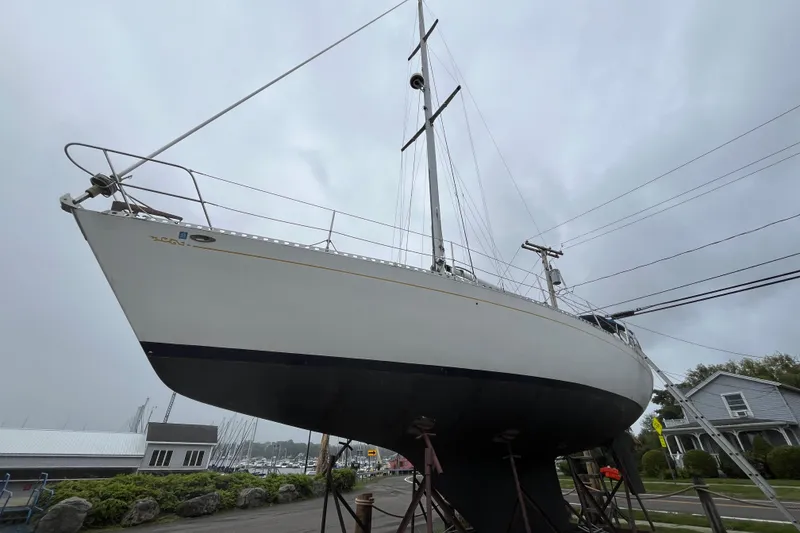 Slide: The Image of 1983 Cheoy Lee Pedrick 41 sailboat on stands, overcast sky background. - 2