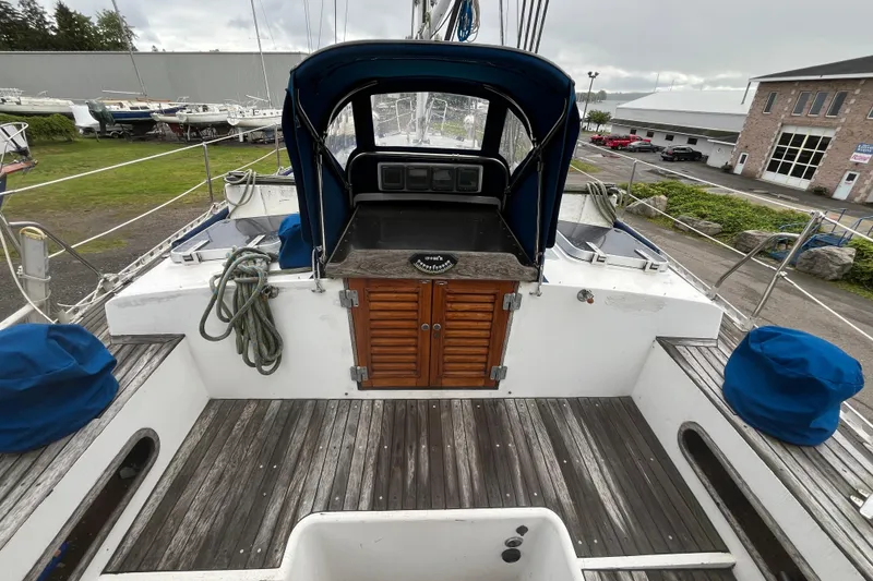 Slide: The Image of 1983 Cheoy Lee Pedrick 41 sailboat cockpit with wooden flooring and blue covers. - 20