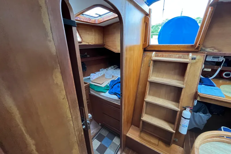 Slide: The Image of Interior of 1983 Cheoy Lee Pedrick 41 sailboat with wooden cabinetry and ladder. - 29