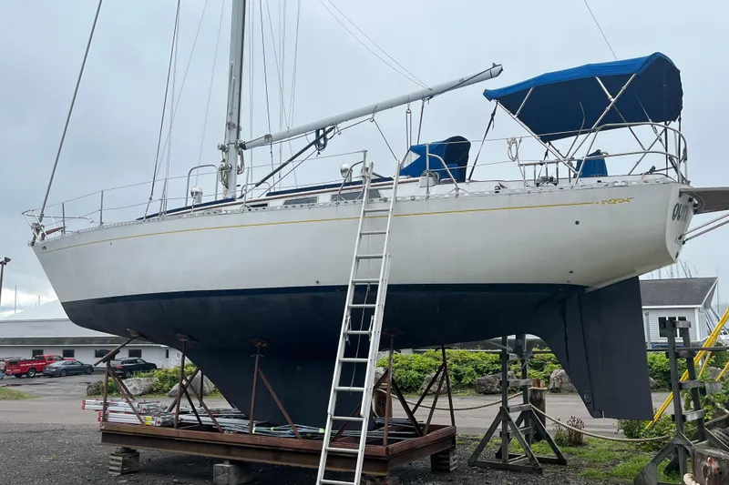 Slide: The Image of 1983 Cheoy Lee Pedrick 41 sailboat on dry dock with blue canopy and ladder. - 3