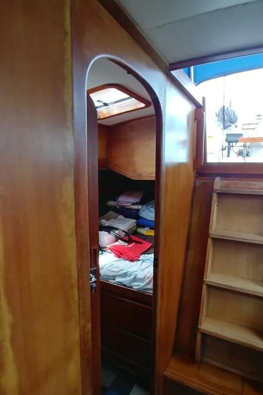 Slide: The Image of 1983 Cheoy Lee Pedrick 41 interior cabin with wooden finish and storage shelves. - 30