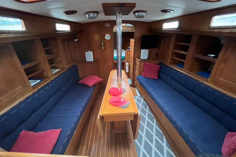 Slide: The Image of Interior of 1983 Cheoy Lee Pedrick 41 sailboat with wooden finish and blue seating. - 37