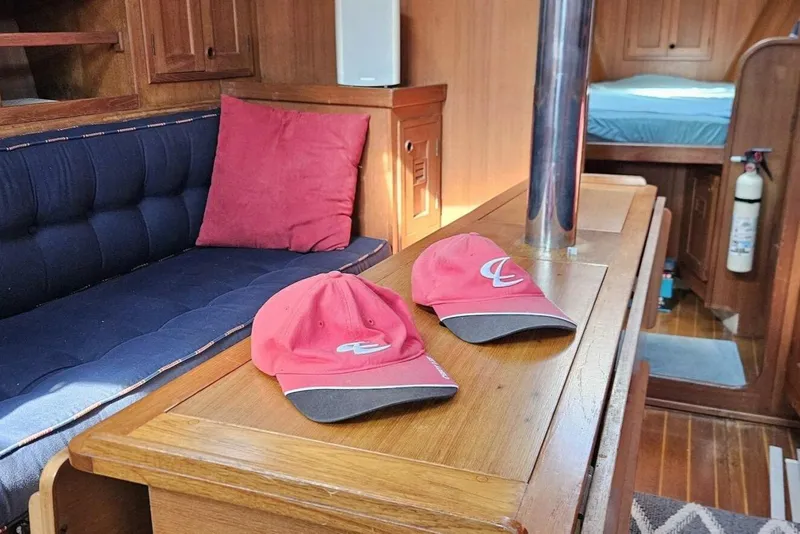 Slide: The Image of Interior of 1983 Cheoy Lee Pedrick 41 sailboat with red caps on wooden table. - 39