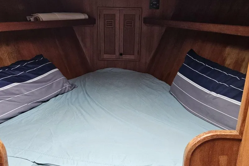 Slide: The Image of Cozy cabin interior of 1983 Cheoy Lee Pedrick 41 sailboat with striped pillows. - 43