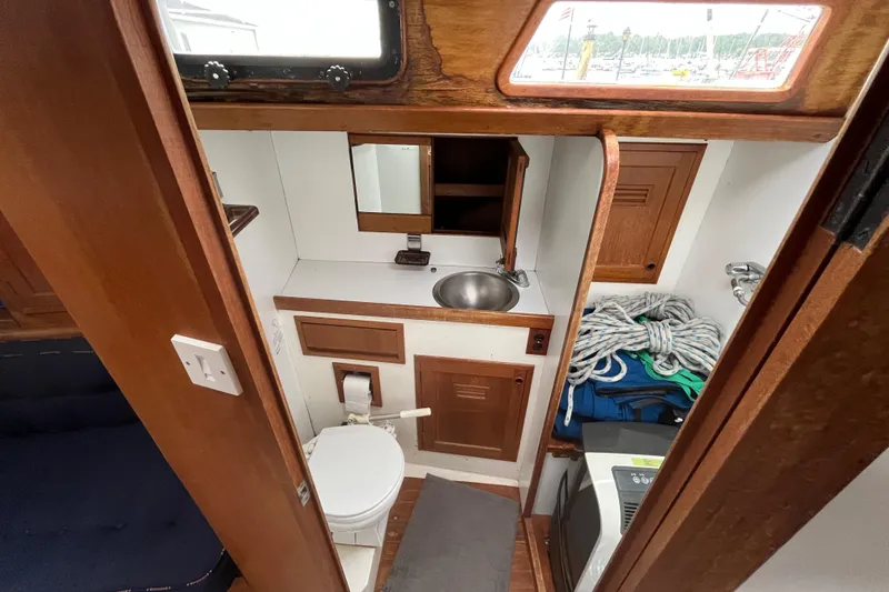 Slide: The Image of 1983 Cheoy Lee Pedrick 41 yacht interior with compact bathroom and storage area. - 46