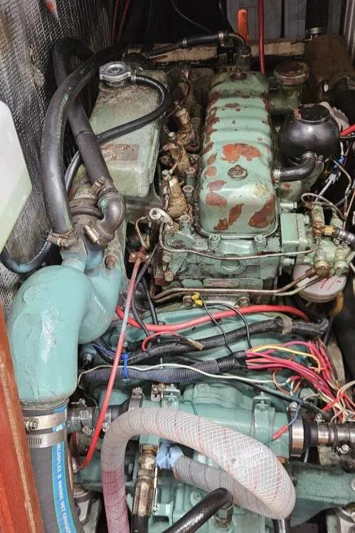 Slide: The Image of Engine compartment of a 1983 Cheoy Lee Pedrick 41 sailboat, showing detailed mechanical components. - 49
