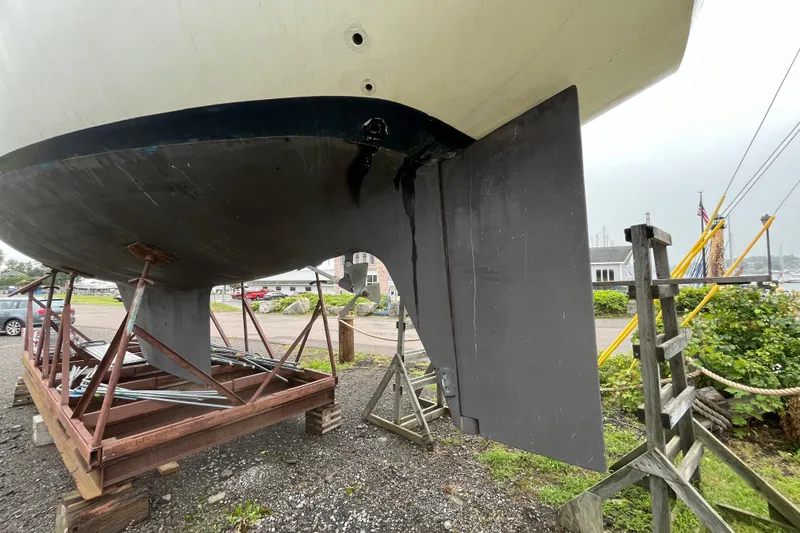 Slide: The Image of 1983 Cheoy Lee Pedrick 41 sailboat on stands, showing hull and rudder detail. - 5