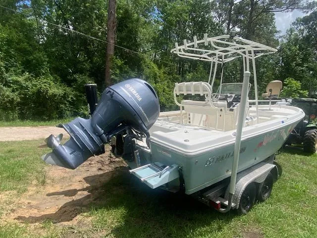 Slide: The Image of 2017 Sailfish 2100 BB Bay Boat with Yamaha outboard motor on trailer, parked on grass. - 12