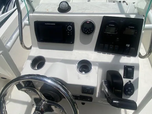 Slide: The Image of 2017 Sailfish 2100 BB Bay Boat console with steering wheel and navigation controls. - 14