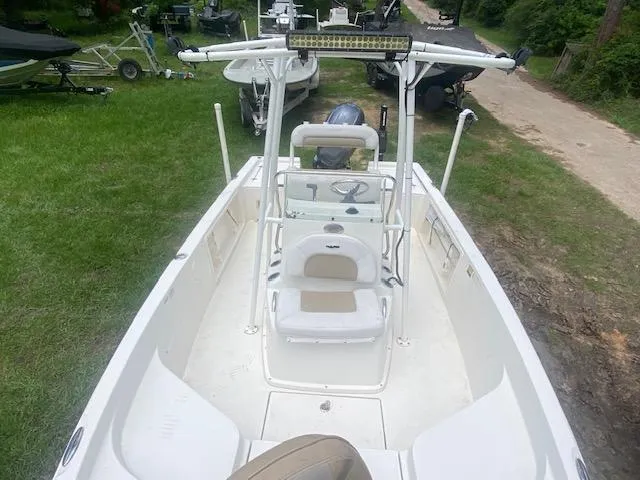 Slide: The Image of 2017 Sailfish 2100 BB Bay Boat with T-top, parked on grass. - 16