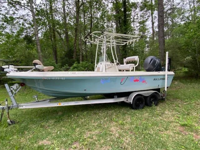 Slide: The Image of 2017 Sailfish 2100 BB Bay Boat on trailer in wooded area. - 7