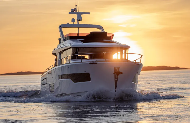 Slide: The Image of Nimbus 495 Flybridge 2025 yacht cruising at sunset on open water. - 27