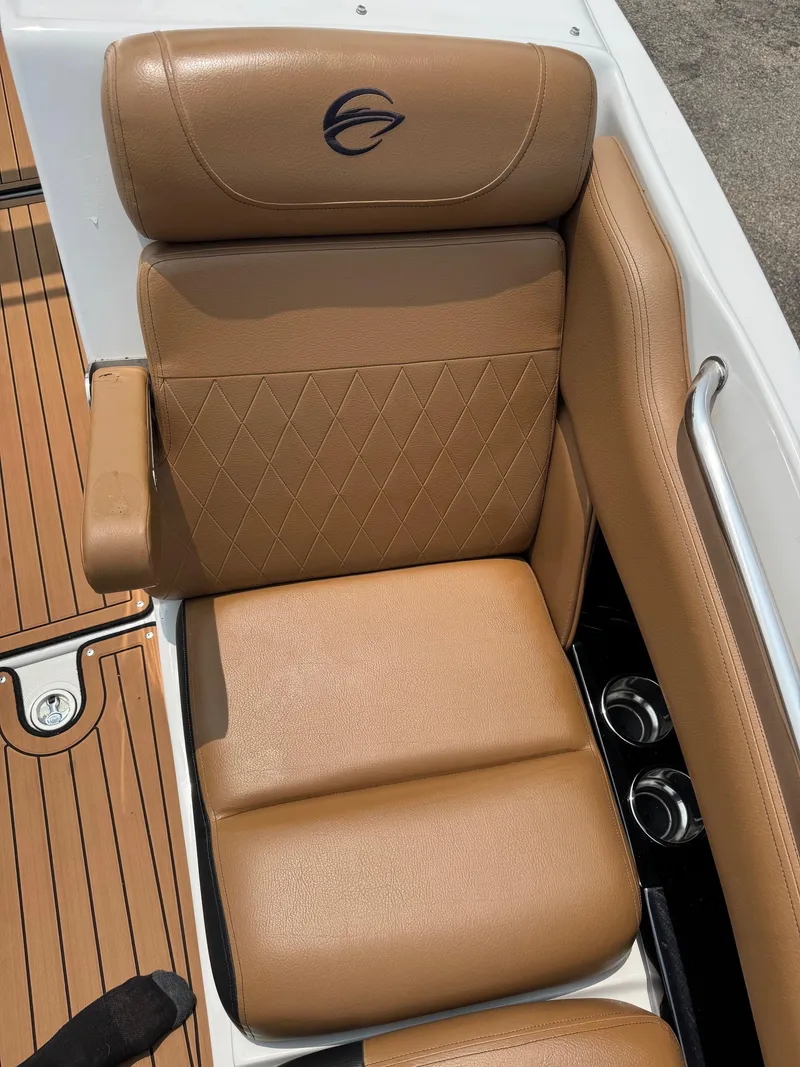 Slide: The Image of 2023 Crownline 280 SS SURF boat seat with tan upholstery and diamond stitching. - 11