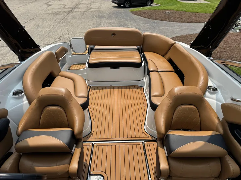 Slide: The Image of 2023 Crownline 280 SS SURF boat interior with luxurious tan seating and teak-style flooring. - 12