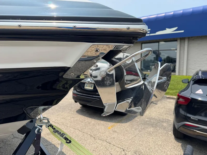Slide: The Image of 2023 Crownline 280 SS SURF boat anchor detail in a dealership parking lot. - 17
